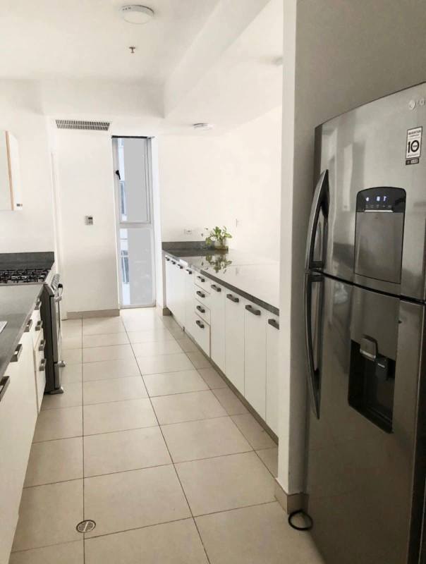 Large living room with floor-to-ceiling windows and bay views at PH Waters Panama City