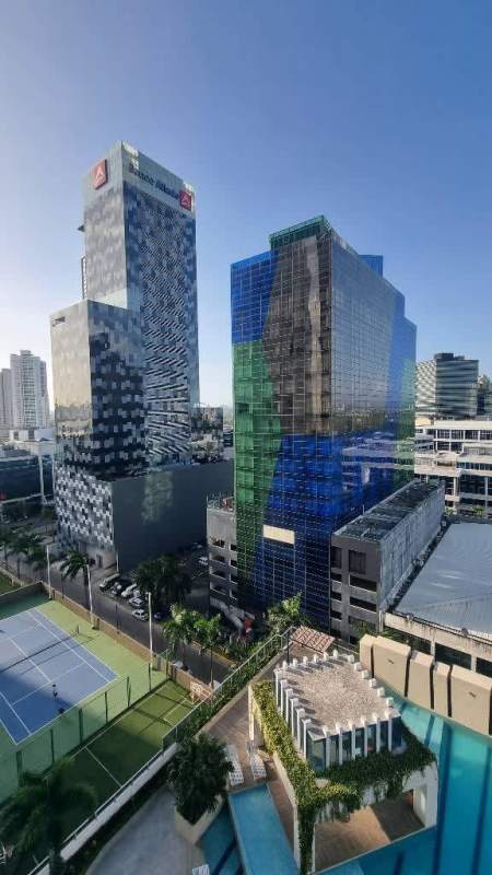 Modern kitchen with marble countertops, dark cabinetry, large window, stainless appliances in PH Regalia Costa del Este Panama