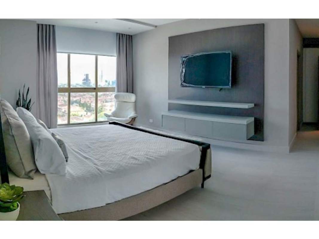 Minimalist bedroom with city views, wall-mounted TV, floating shelves in PH Park View Costa del Este Panama