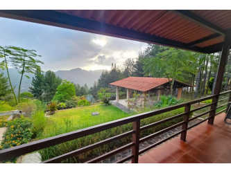 Covered wooden patio with mountain scenery and garden views in Altos del María Panama