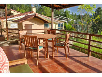 Rustic cabin-style porch surrounded by pine forest in Altos del María Panama