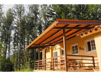 Wooden cabin porch with pine trees surroundings in Altos del María Panama