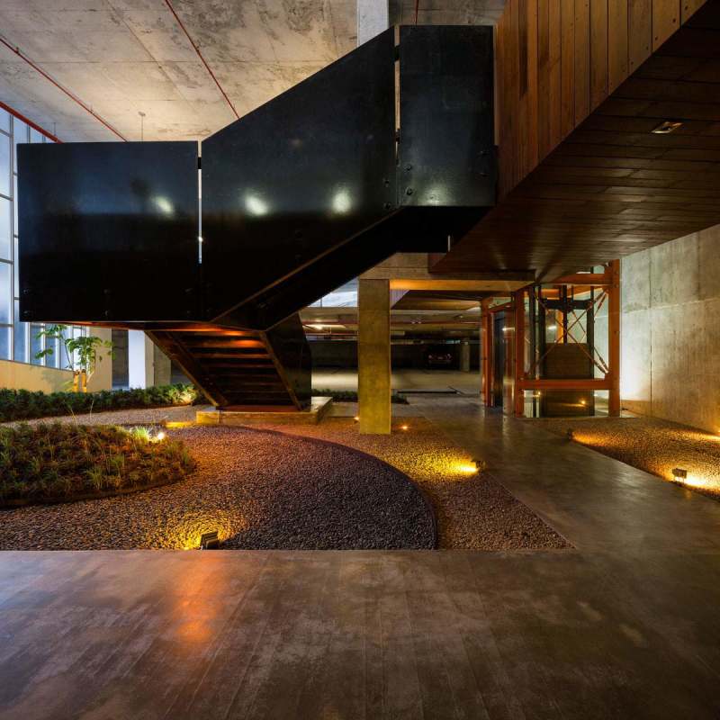 Lobby with black staircase, indoor garden, wood ceiling, concrete design at Midtown Tower Panama