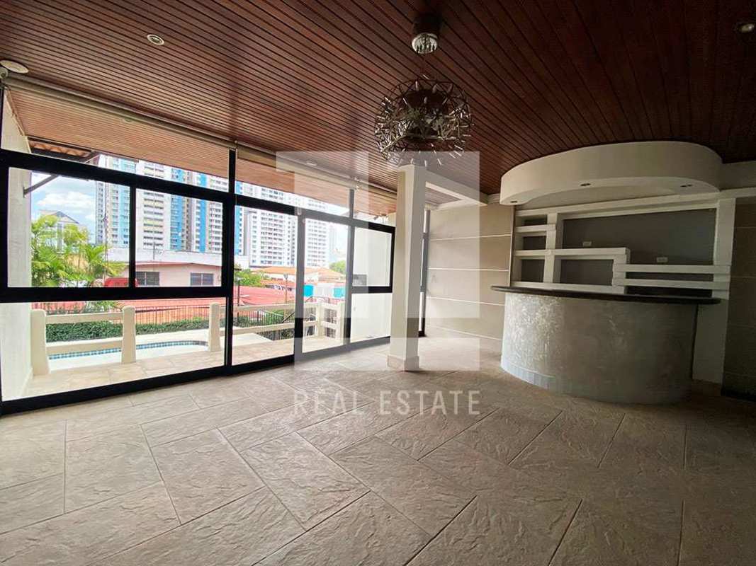 Bright kitchen with blue accents, island, white cabinets, gas stove, large windows Dos Mares Panama