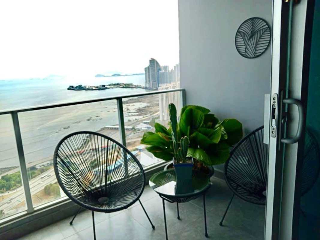 Private balcony overlooking Pacific Ocean and city skyline in luxury penthouse PH Coco del Mar Panama City