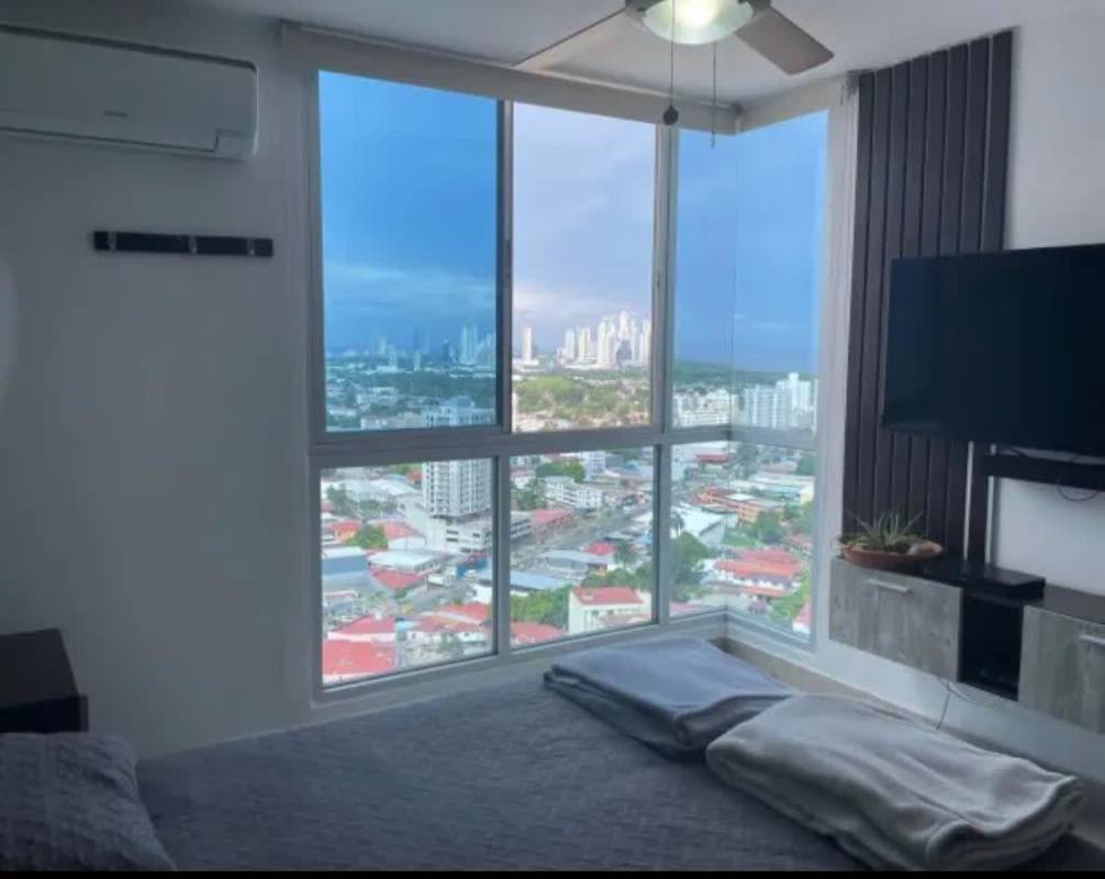 Fully equipped kitchen with breakfast bar, wooden cabinetry, and stainless appliances PH Coral Towers Panama City