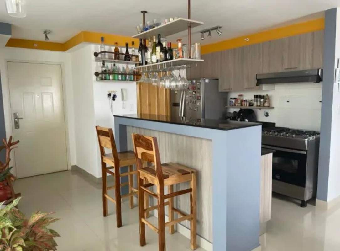 Bedroom with large corner windows overlooking Panama skyline, ceiling fan, closet in PH Coral Towers