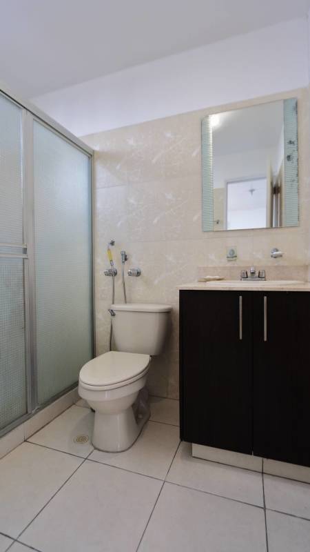 Modern bathroom with walk-in glass-enclosed shower apartment for sale PH Montemar San Francisco Panama