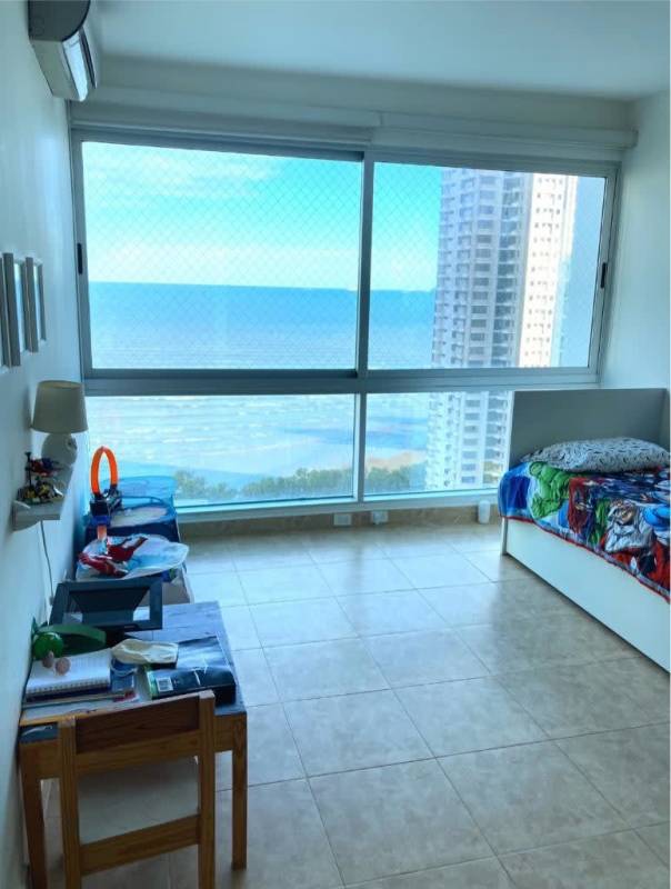 Spacious open-plan living room leading to balcony with ocean views in PH Titanium Panama