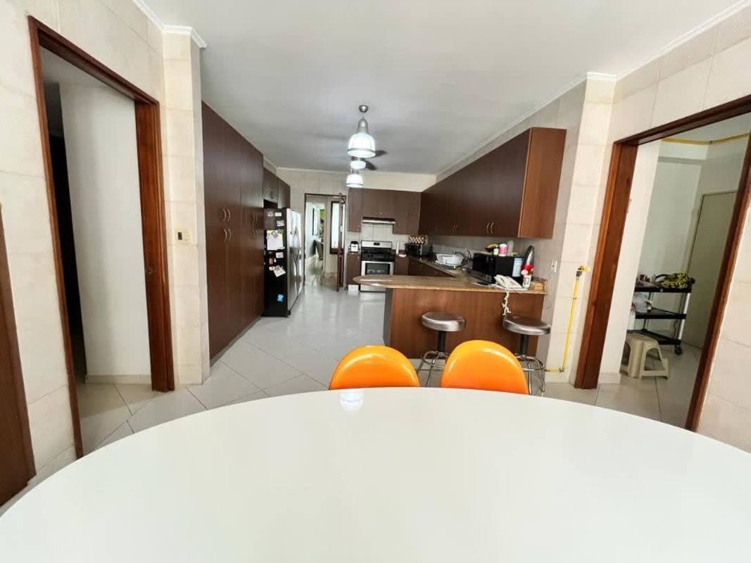 Luxurious entertainment room featuring built-in bar area, marble floors, eclectic decor PH Peninsula Panama City