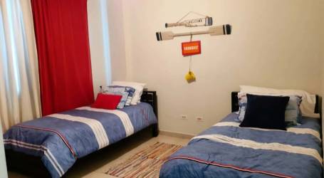 Twin beds with nautical decor and coastal theme at PH Rodman Bijao Panama