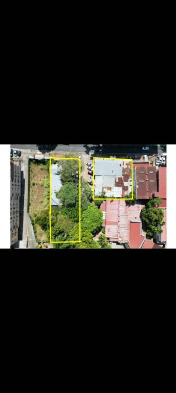 Aerial perspective showing two adjacent lots one vacant one with buildings in El Cangrejo commercial district Panama