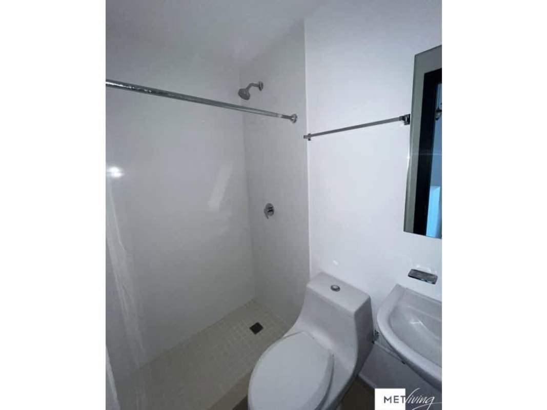 Minimalist white bathroom with walk-in shower in Altos del Crisol townhouse Villa Lucre Panama
