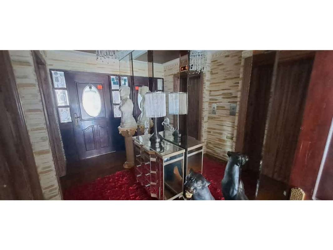 Large living room with city view, sofas, art and chandelier in PH Ritz Punta Paitilla Panama