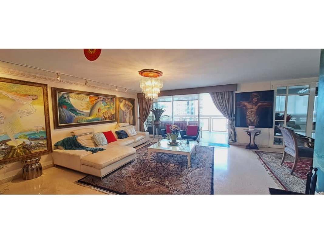 Spacious living and dining with murals, chandeliers, sofas at PH Ritz Punta Paitilla Panama City