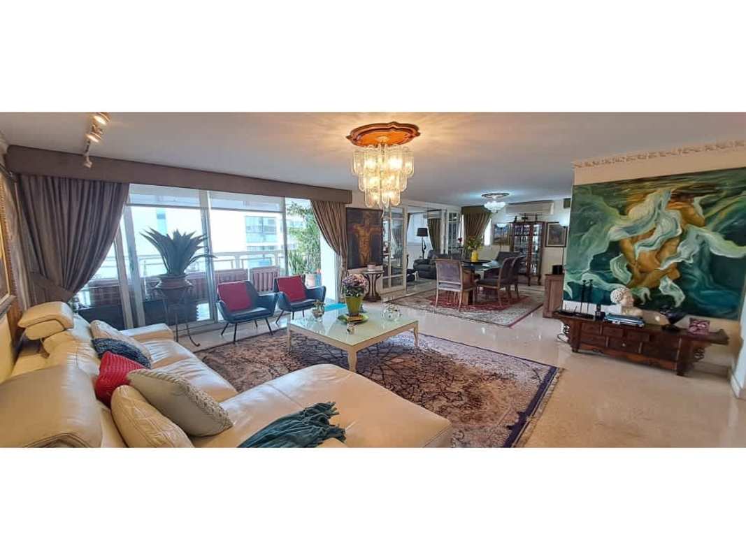 Living area with marble columns, leather sofas, art, panoramic windows PH Ritz Panama