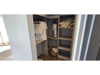 Walk-in closet with shelves and modern lighting at Centriqo Panama Pacifico