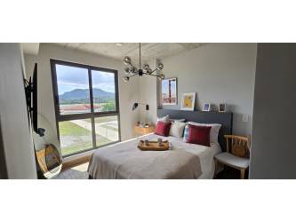 Bedroom with large window and mountain view in Centriqo Panama Pacifico Panama City