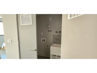 Modern pool with submerged loungers and greenery at Centriqo Panama Pacifico