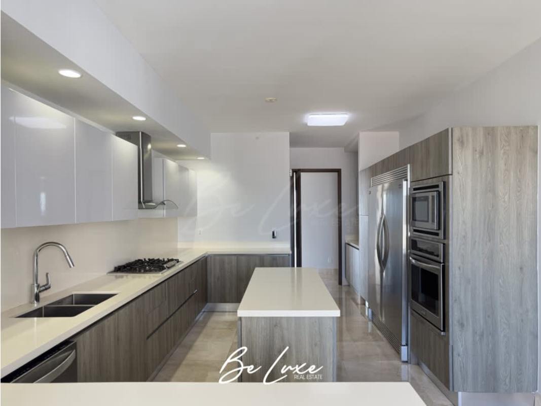 Spacious modern kitchen with island, granite countertops, top appliances in PH Green Garden Santa María Panama