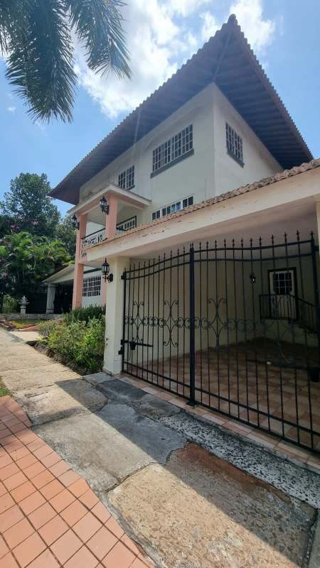 Indoor landing area with panoramic windows offering views of lush garden and swimming pool in prestigious Clayton home Panama
