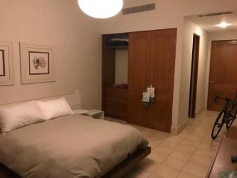 Bedroom with modern tile floor, built-in wood closet, minimalist decor in Paseo de la Casa Buenaventura Panama