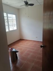 Bedroom with ceiling fan and tiled floor in family house for sale Chitre Los Santos Panama Hola Realty