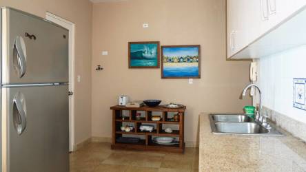 Modern kitchen with granite countertops, stainless appliances at PH Playa Blanca Farallón beach condo Panama