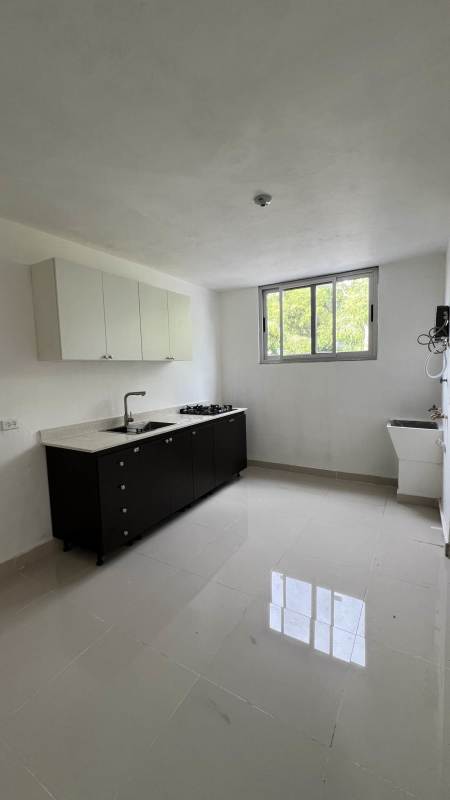 Bright modern kitchen with window black white cabinets Panama City rental