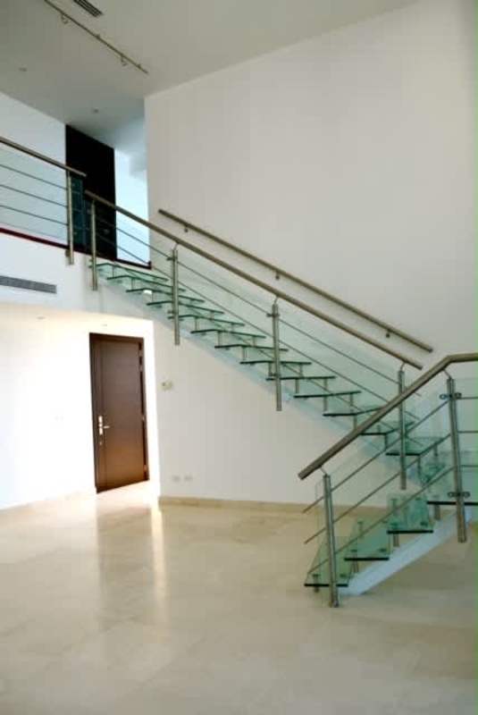 Elegant marble foyer and modern glass staircase in Aqualina penthouse Punta Pacifica Panama