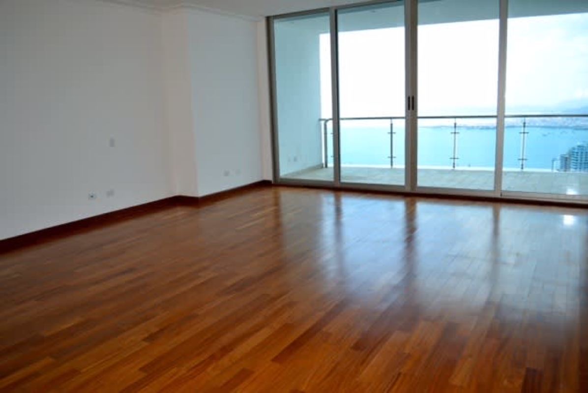 Spacious living area with glass doors to balcony and hardwood floor at PH Aqualina