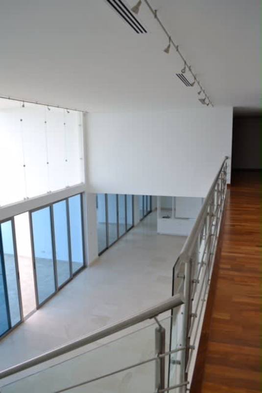 Upstairs overlook hall with modern railing and glass walls PH Aqualina Penthouse Panama