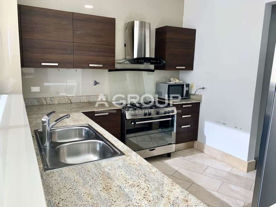 Elegant bedroom with balcony access, ocean views, built-in closets in Grand Tower Punta Pacifica Panama