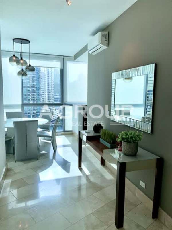 Modern dining space with large windows, vibrant city views Grand Tower Punta Pacifica Panama