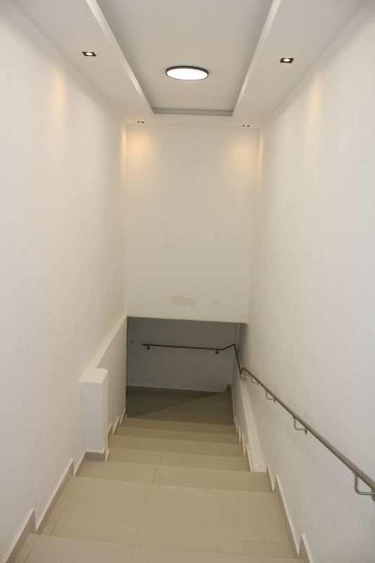 Modern kitchen with granite counters, marble accent wall, window with bars in Villa Zaita Panama