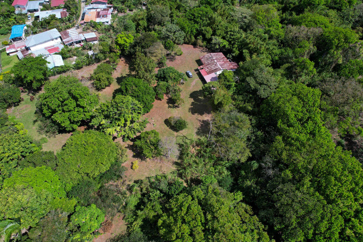 Aerial view rustic farmhouse metal roof lush mountain lot El Valle Panama