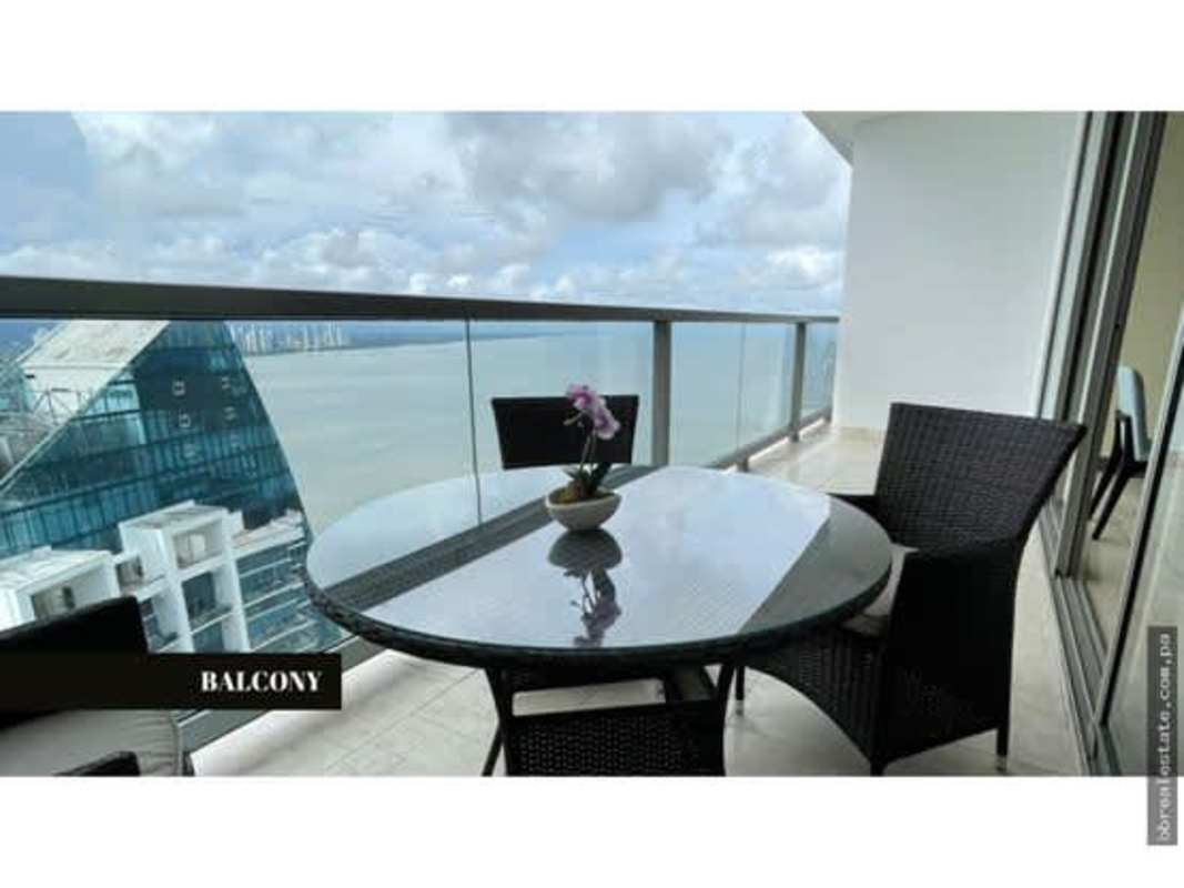 Dining table set against floor-to-ceiling windows with Panama skyline at PH The Ocean Club