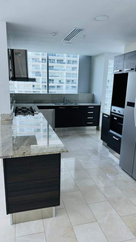 Modern kitchen with granite countertops, stainless steel appliances, city and sea views at Grand Tower Punta Pacifica