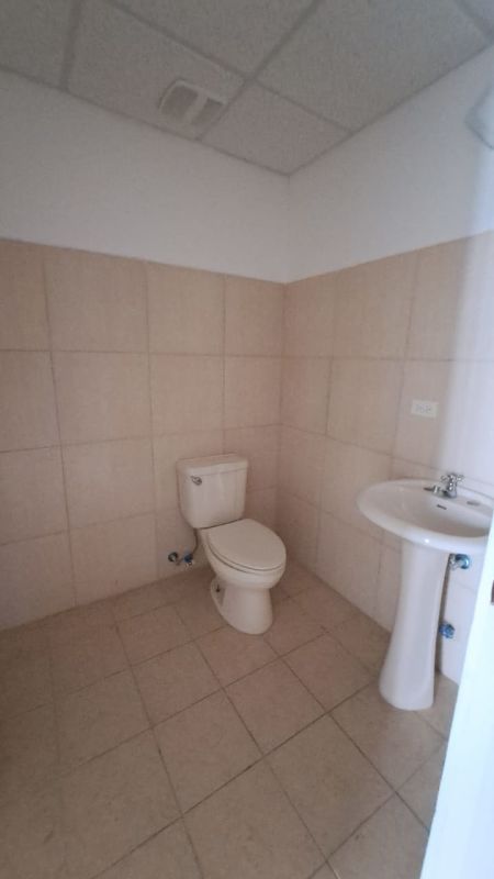 Private office room inside commercial space with glass walls white tile in Plaza Korintho Panama City