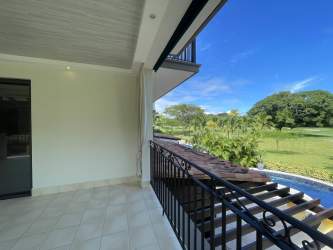 Large covered terrace with railing and garden views at Buenaventura Paseo de las Casas beach condo