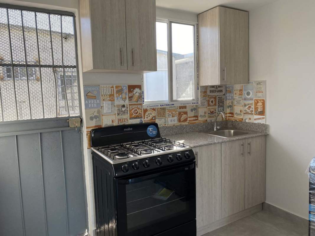 Minimalist open kitchen living space with tile flooring and bright windows Pacora
