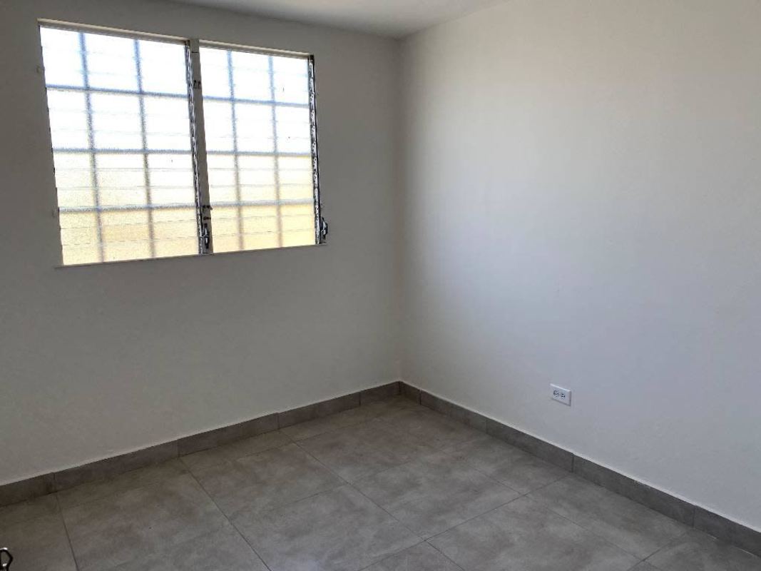 Empty bedroom with tiled floor and large window Pacora Panama affordable rental