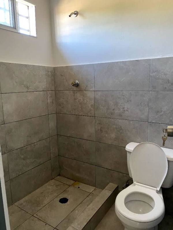 Contemporary bathroom with walk-in shower and modern vanity in Pacora affordable rental
