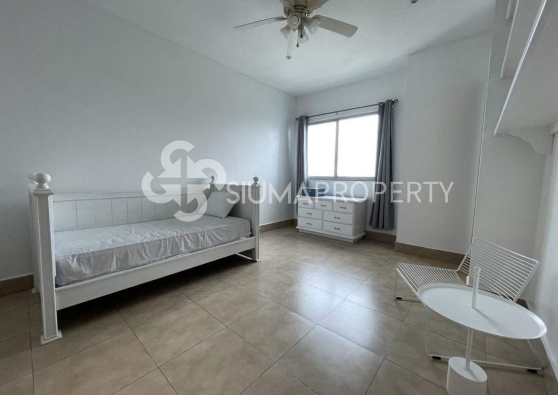 Minimalist bedroom with white furniture and tile floors Costa del Este Panama