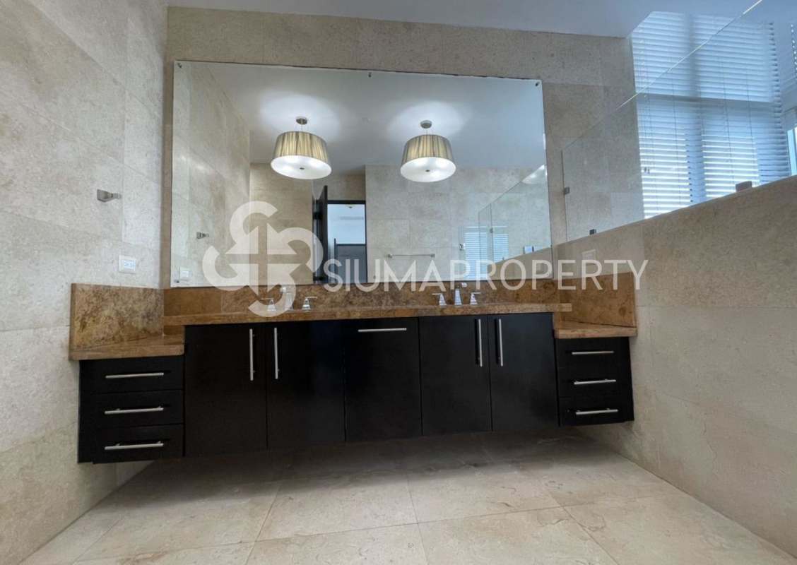 Bright guest bedroom with large windows and ceiling fan PH Costa del Este Tower