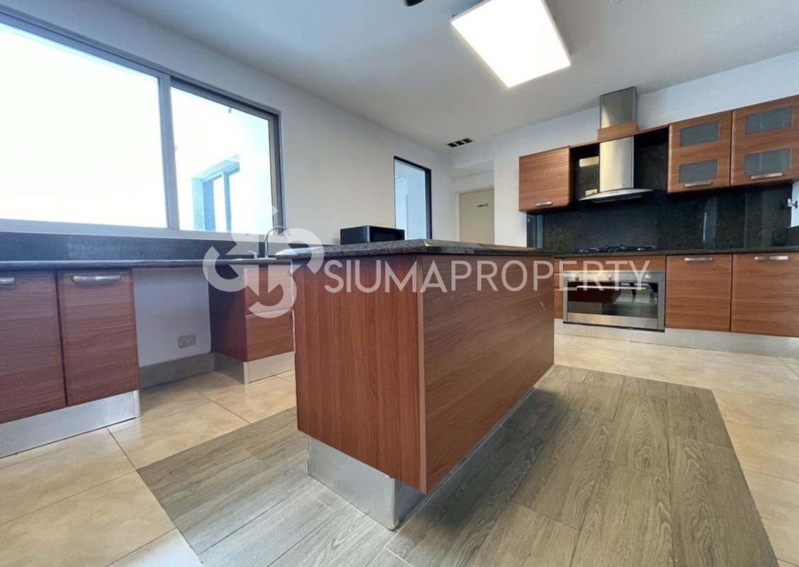 Modern kitchen with wood cabinetry, granite countertops, center island Costa del Este Panama