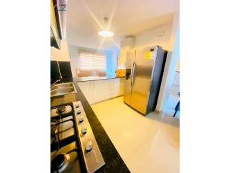 Kitchen with granite countertop, stainless refrigerator, built-in gas stove Senderos de Bambú Panama