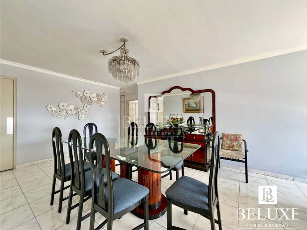 Elegant dining room with large glass table and natural light in PH Country Park Panama City