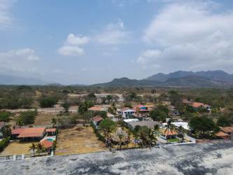 Aerial of residential area and mountains beyond Nueva Gorgona beachfront lot