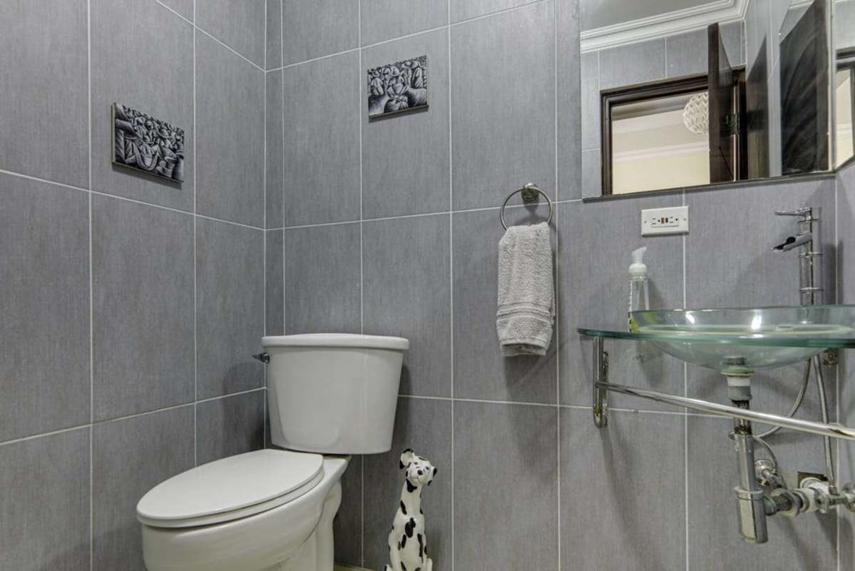 Renovated bathroom with marble double sink vanity and decorative tile Albrook Panama